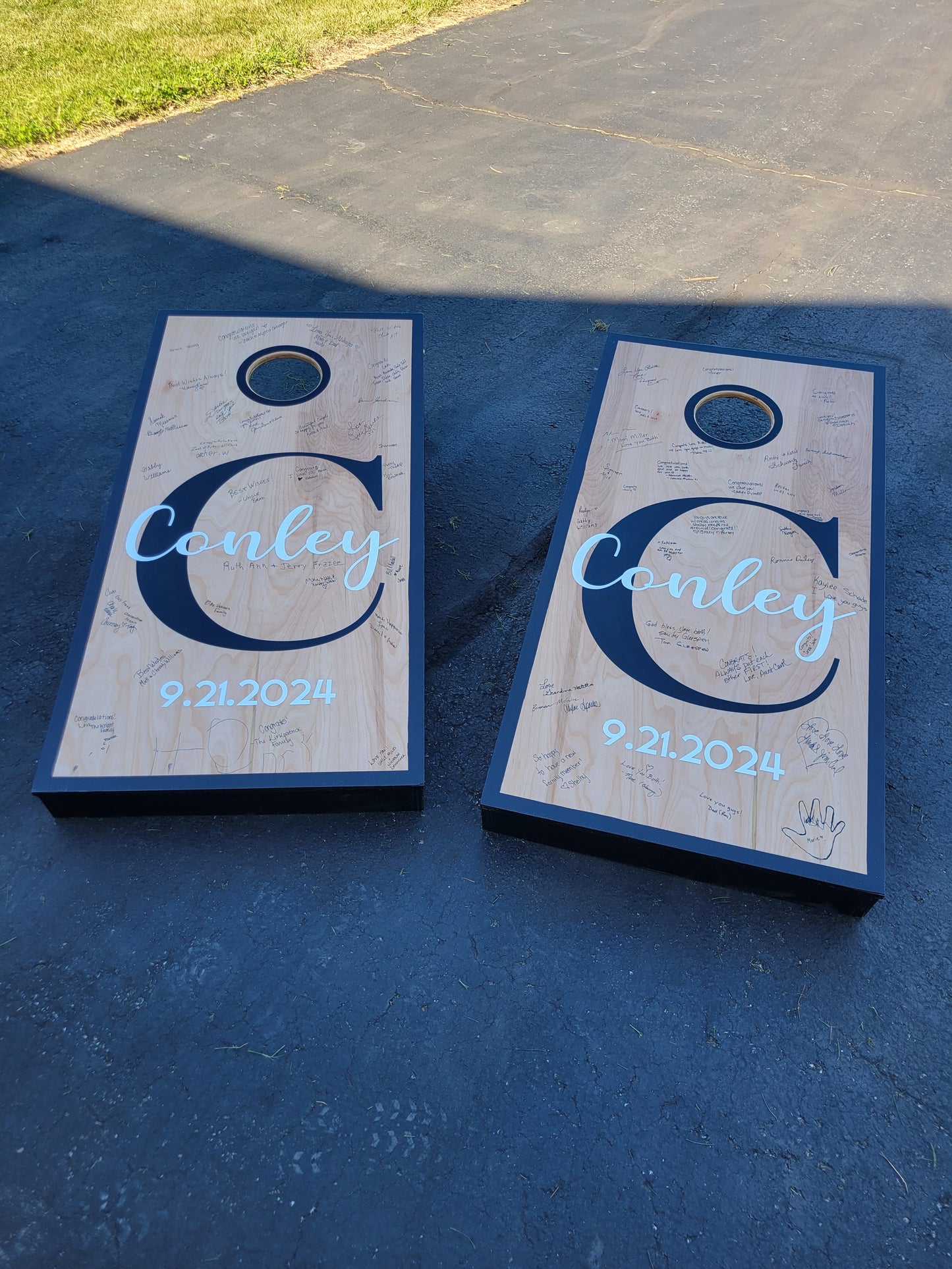 Wedding design cornhole board set, with guest signatures.