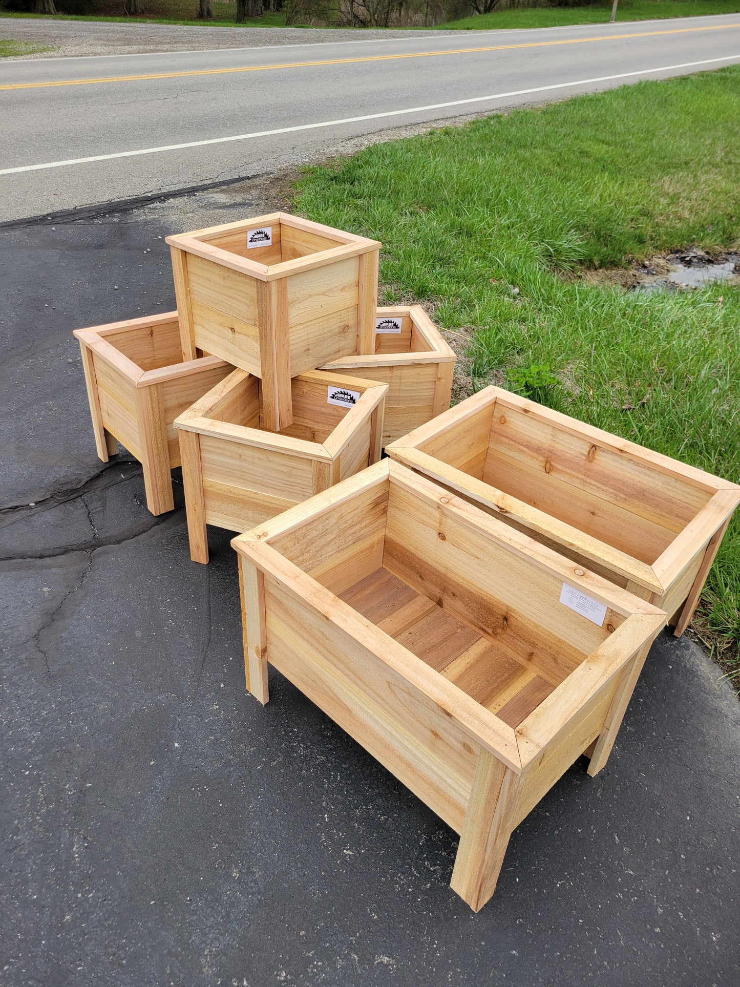 Stack of wooden crates on a road next to grass