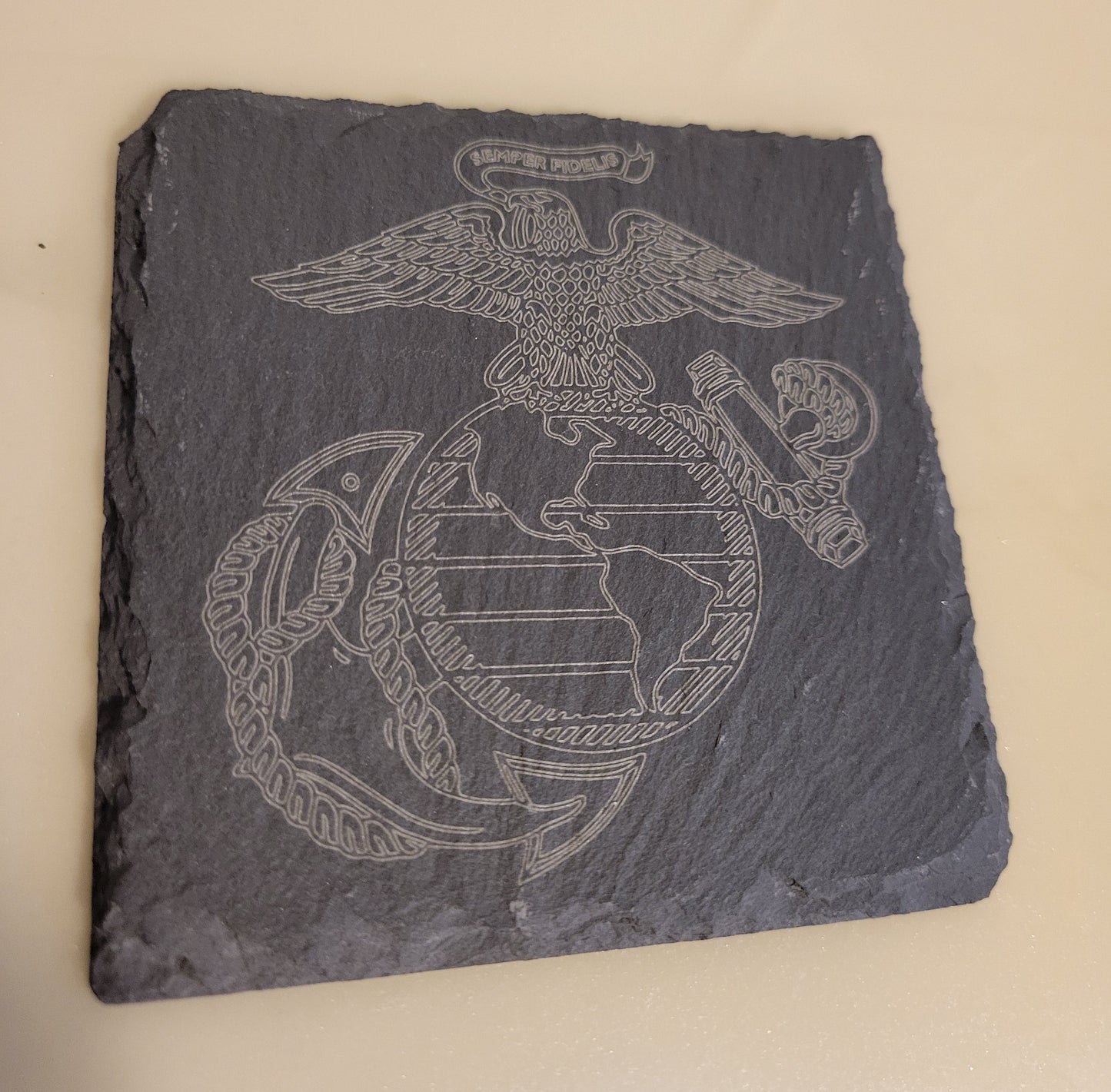 Slate coaster with engraved United States Marines logo.