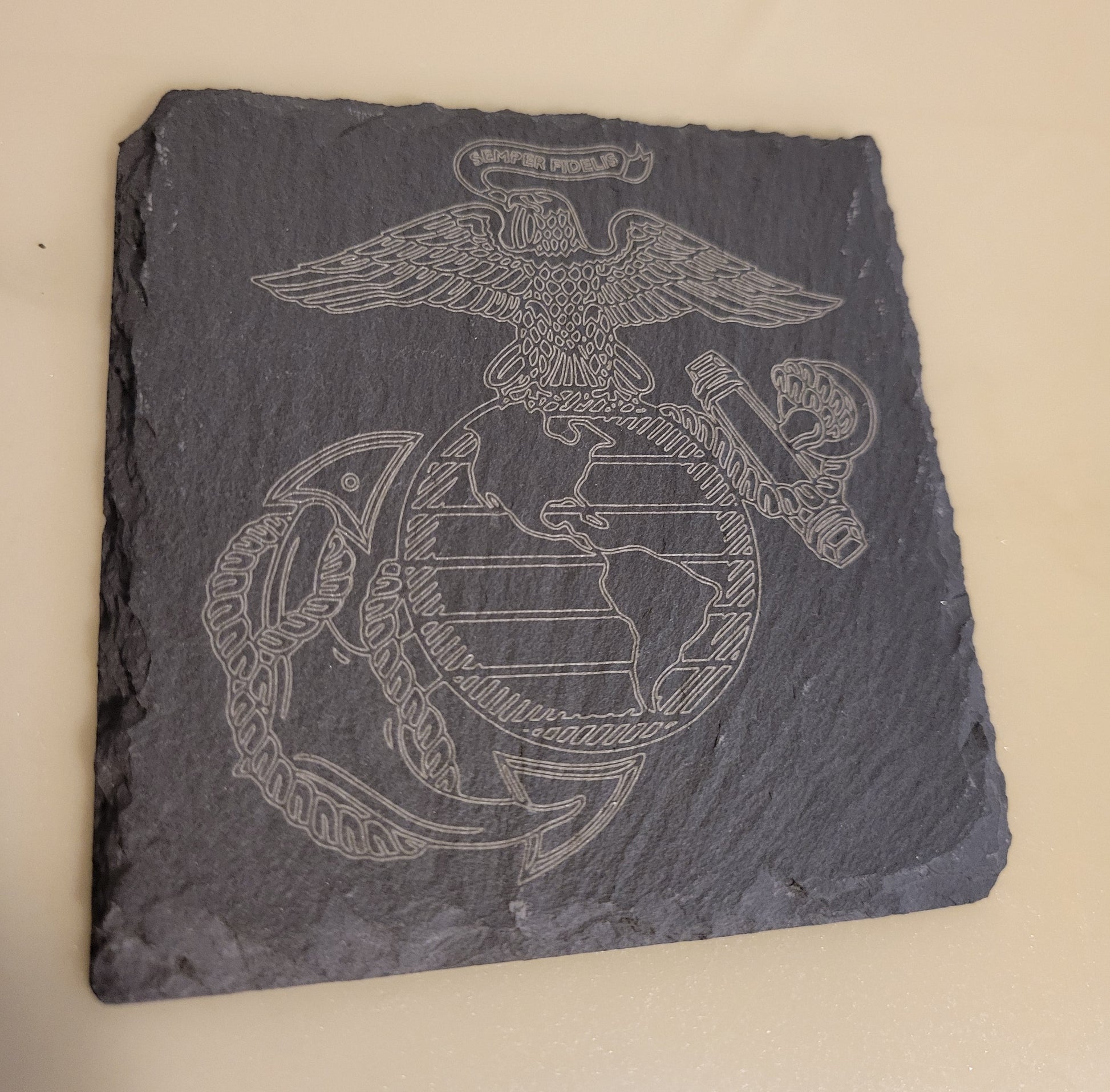Slate coaster with engraved United States Marines logo.