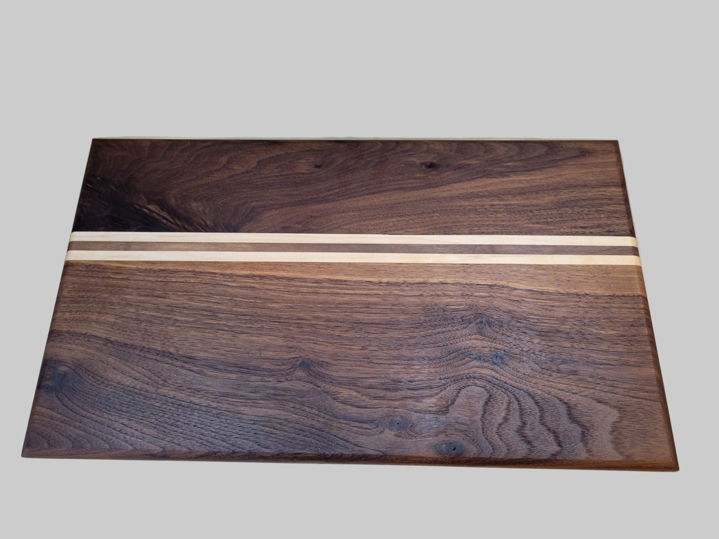A rectangular wooden wall art panel with a dark brown wood grain design and two vertical light beige wood inlay stripes, shown against a solid gray background.